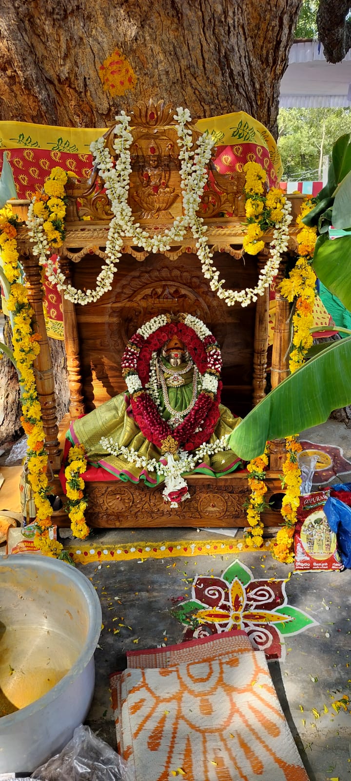 Tree shrine deity decorated with garlands